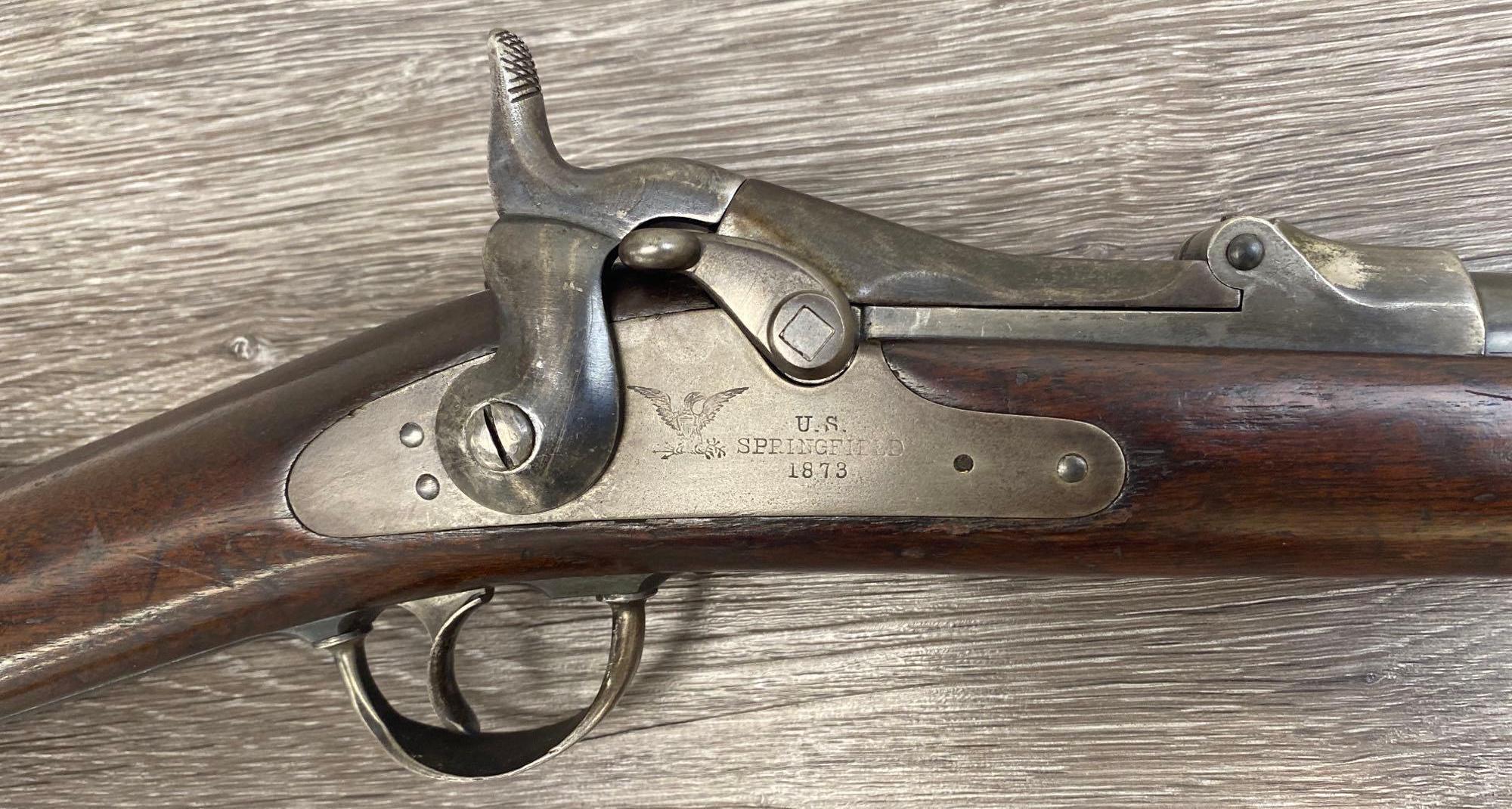 Vintage Springfield 1873SRC lever action rifle in .45-70 with a clear cartouche, showing signs of historical use and age.