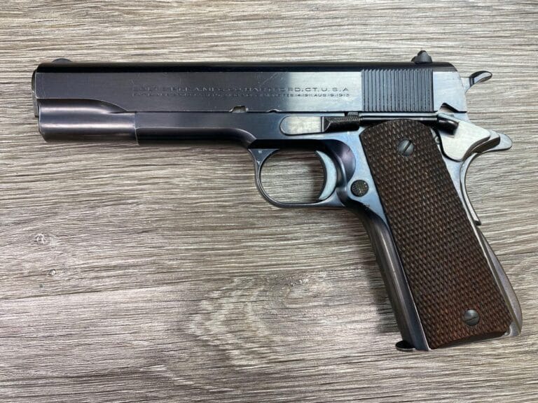 Vintage Colt 1911 National Match Government Model pistol in .45 ACP with a blue finish, wooden grips, and original factory box.